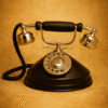 Vintage black and silver rotary telephone with warm textured beige background and soft lighting