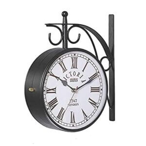 Vintage double-sided black railway wall clock with Roman numerals and wrought iron frame.