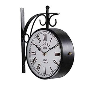 Vintage double-sided black railway wall clock with Roman numerals and wrought iron frame.