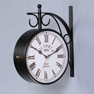 Vintage double-sided black railway wall clock with Roman numerals and wrought iron frame.
