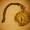 Antique gold pocket watch with Roman numerals and chain on warm textured beige background